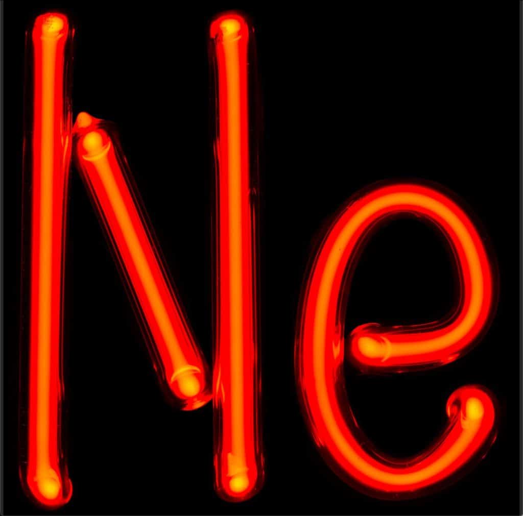 Traditional neon signs using neon gas in a sealed tube made of glass glow a reddish/orange color