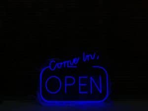 Blue LED - "Come in we are open" sign in dark room